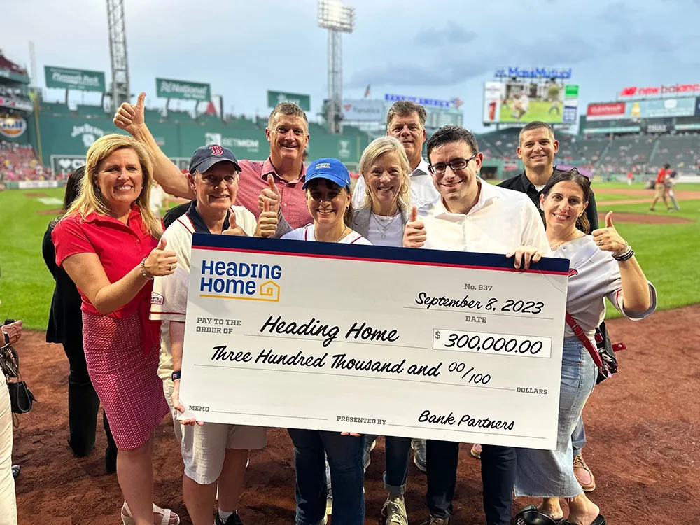 Group of Bankers at Fenway Park holding a big check