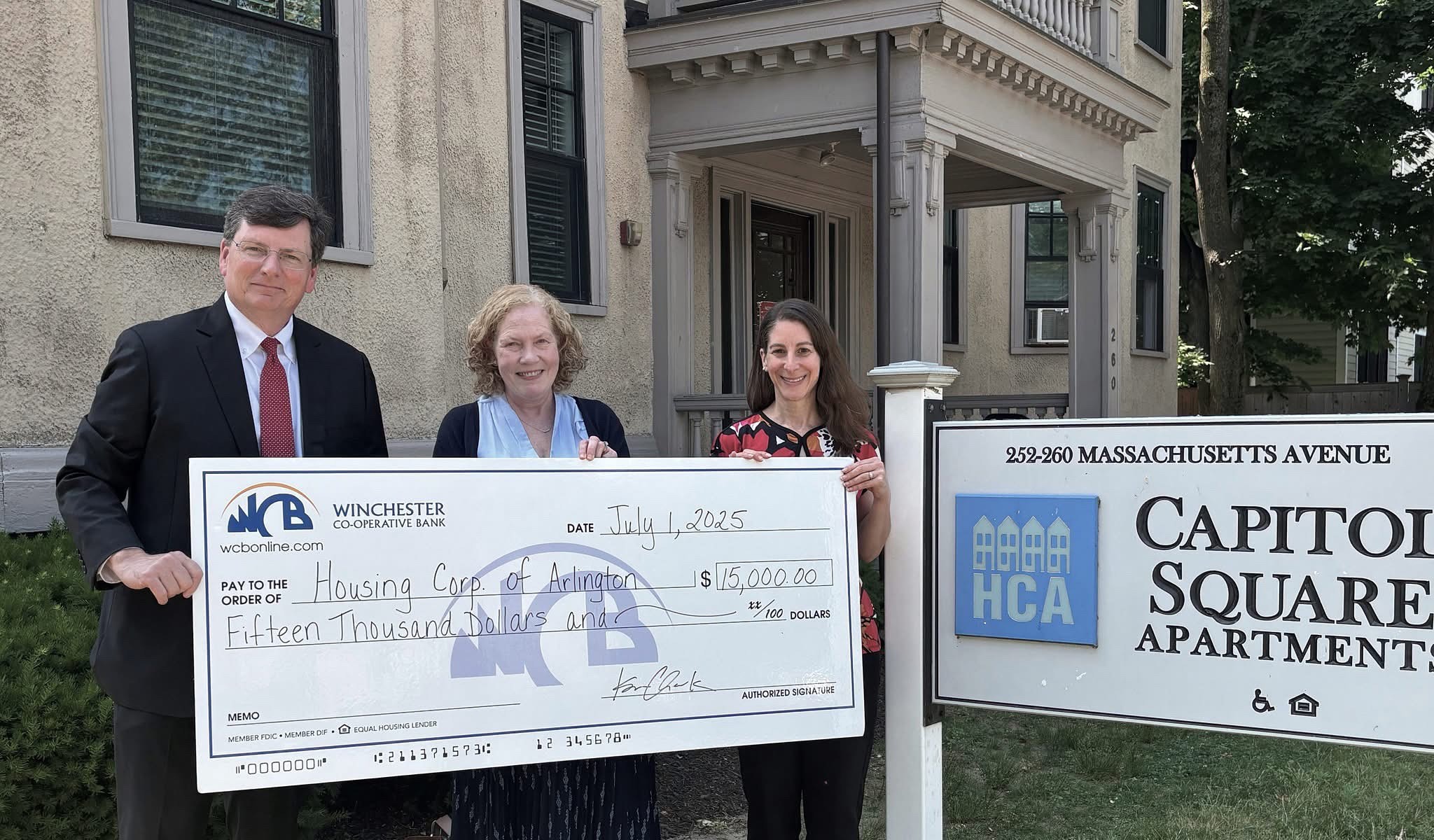 Steve, Julie and Erica holding the big check make out to HCA