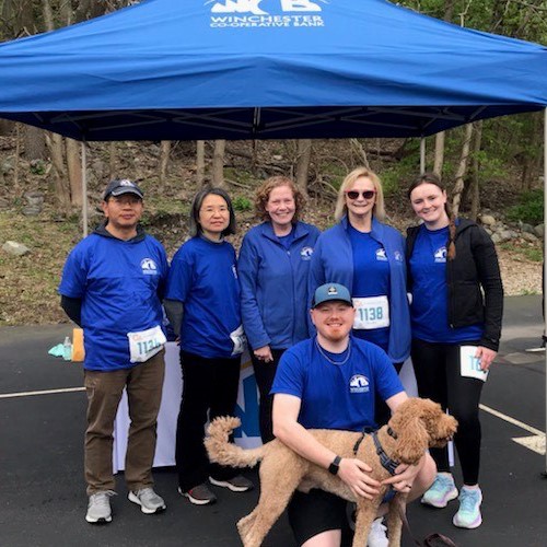 Employees and Jay;s dog at the Race and Walk