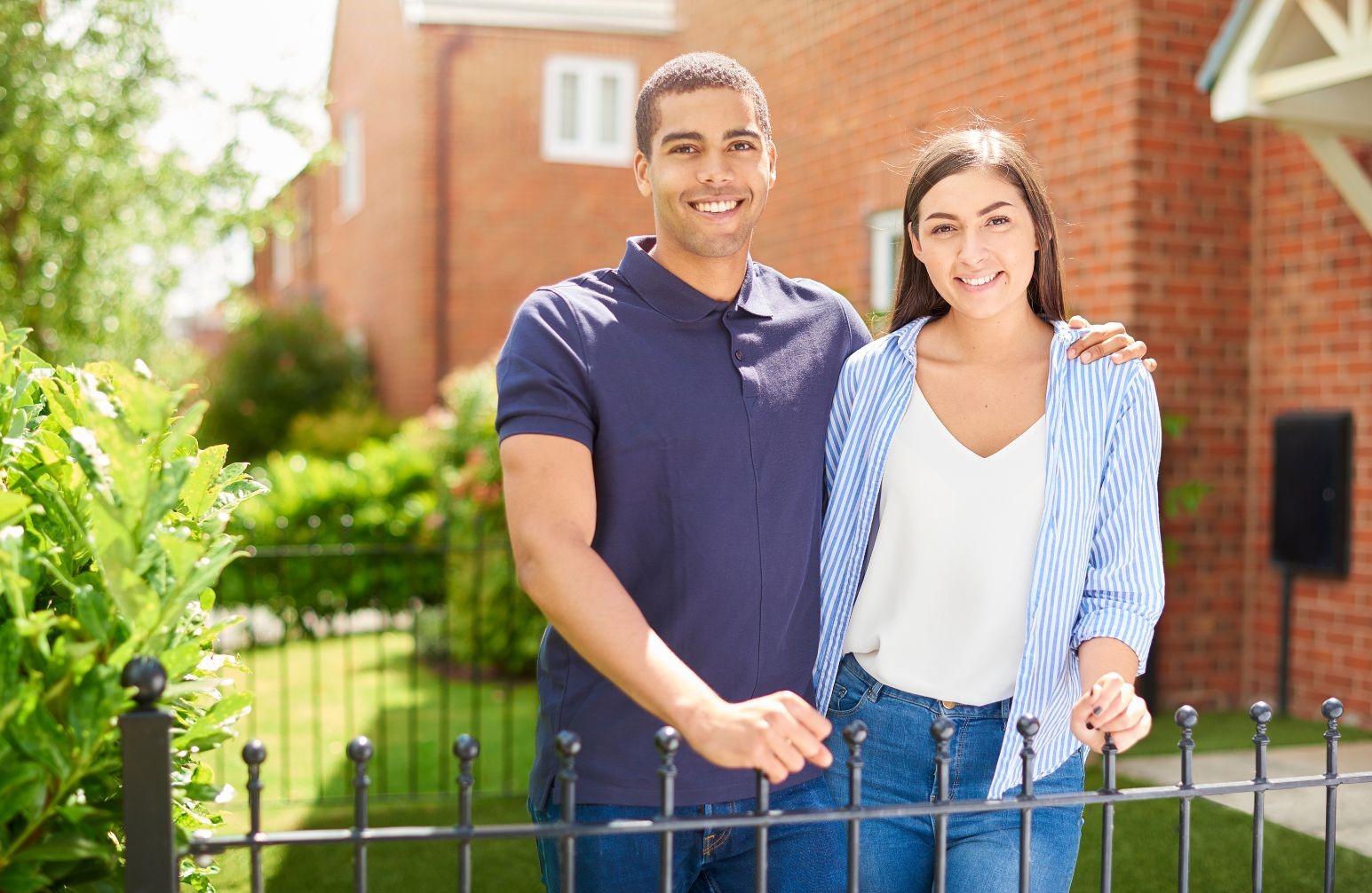 couple in front of a home