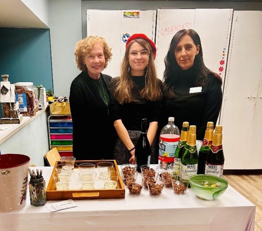 Julie, Mary and Saida standing at a table.