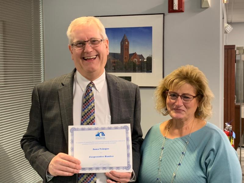 Paul and Anna holding a certificate