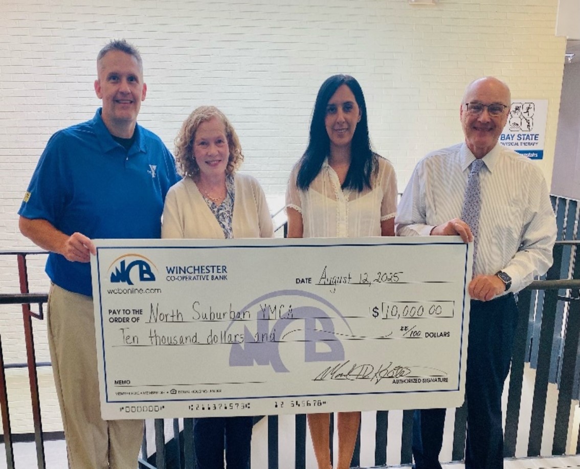 Donny from YMCA and Mark and Saida, Julie holding big check