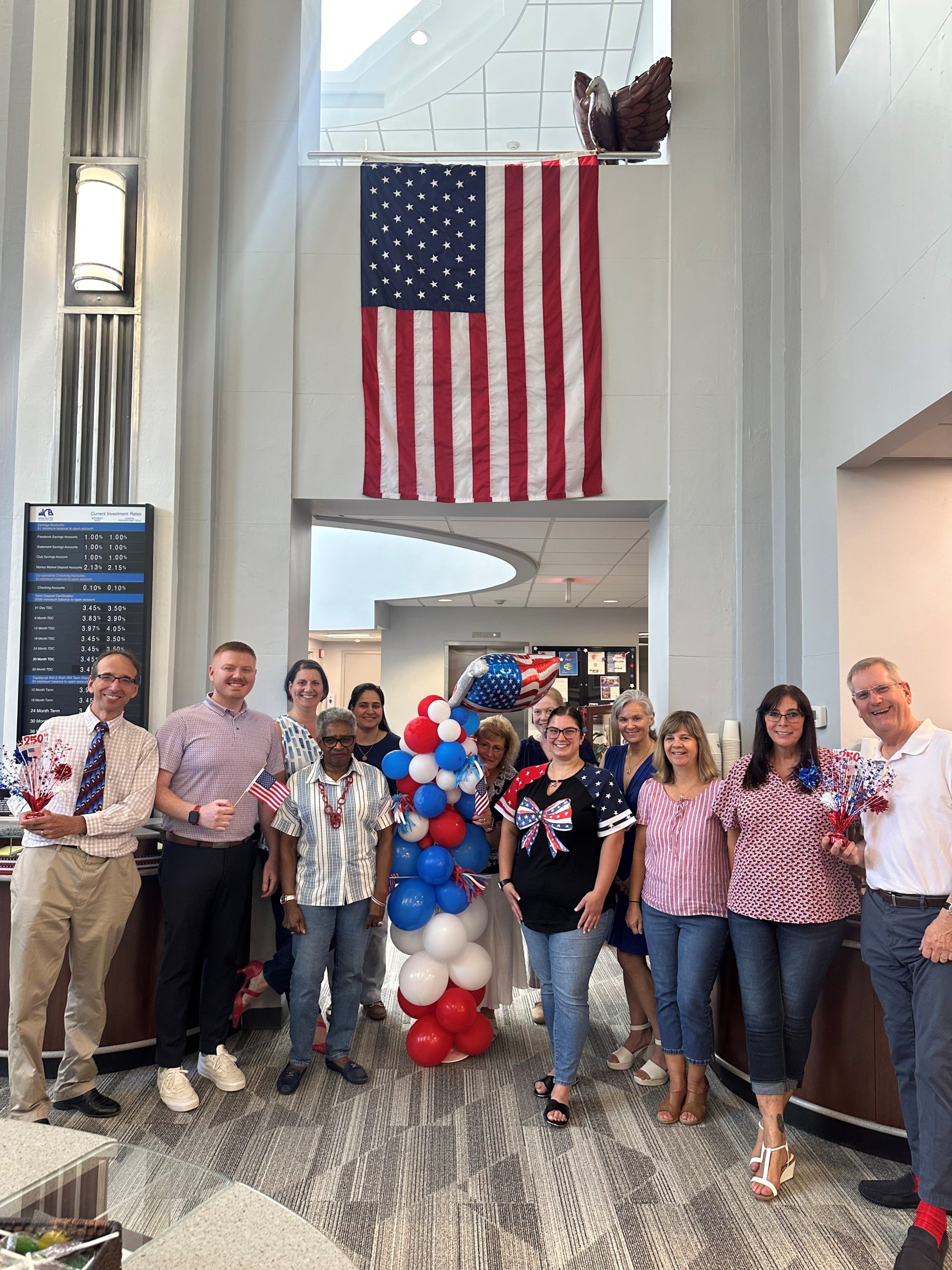 Retail group in front of flag