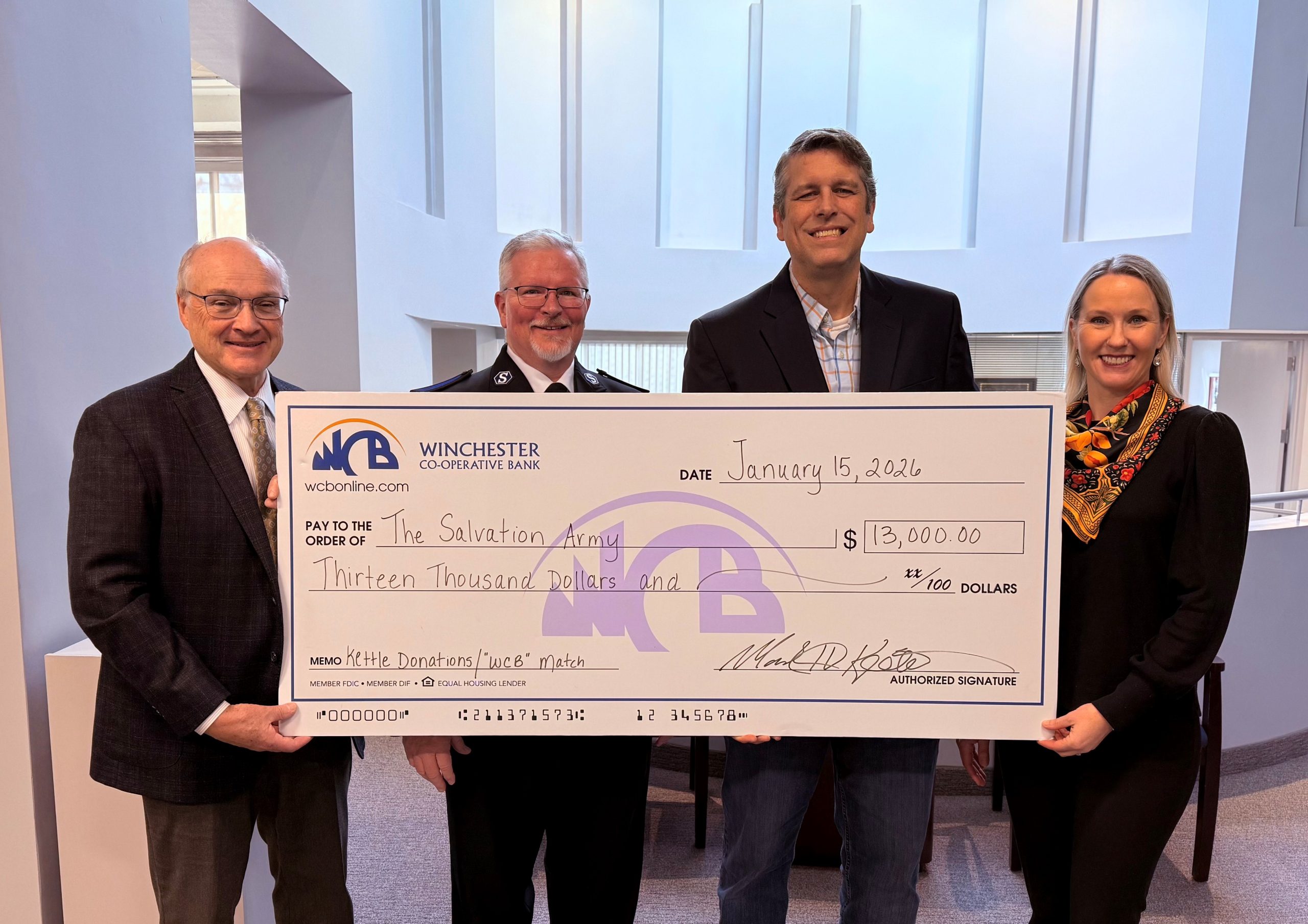 Mark, Wil from SA, and the Gordons holding a big check in the bank