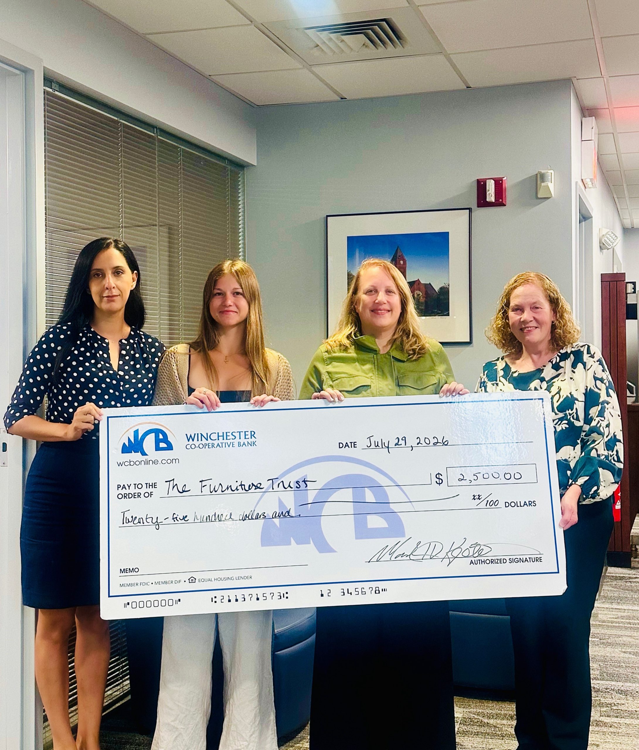 4 women with the check