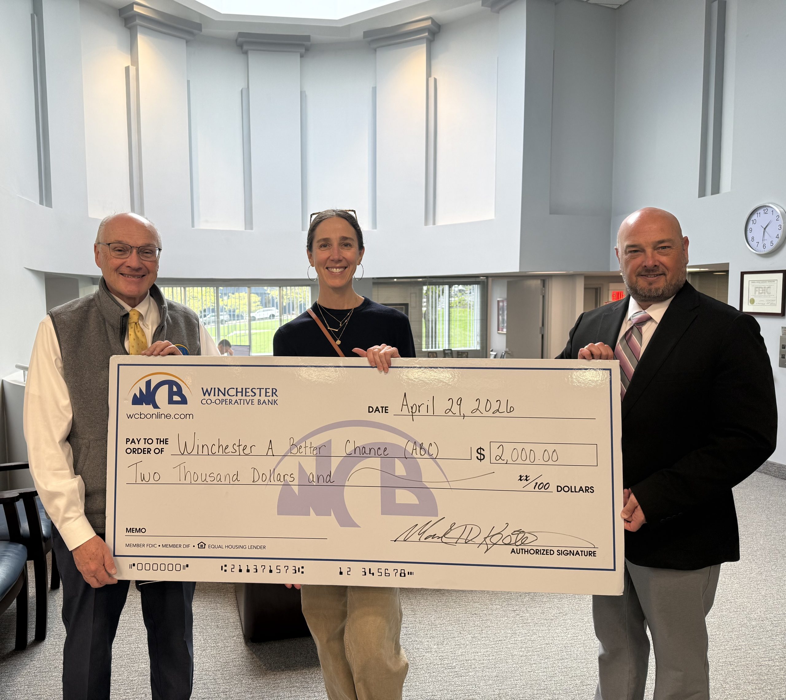 Mark, Christie and Chris holding check