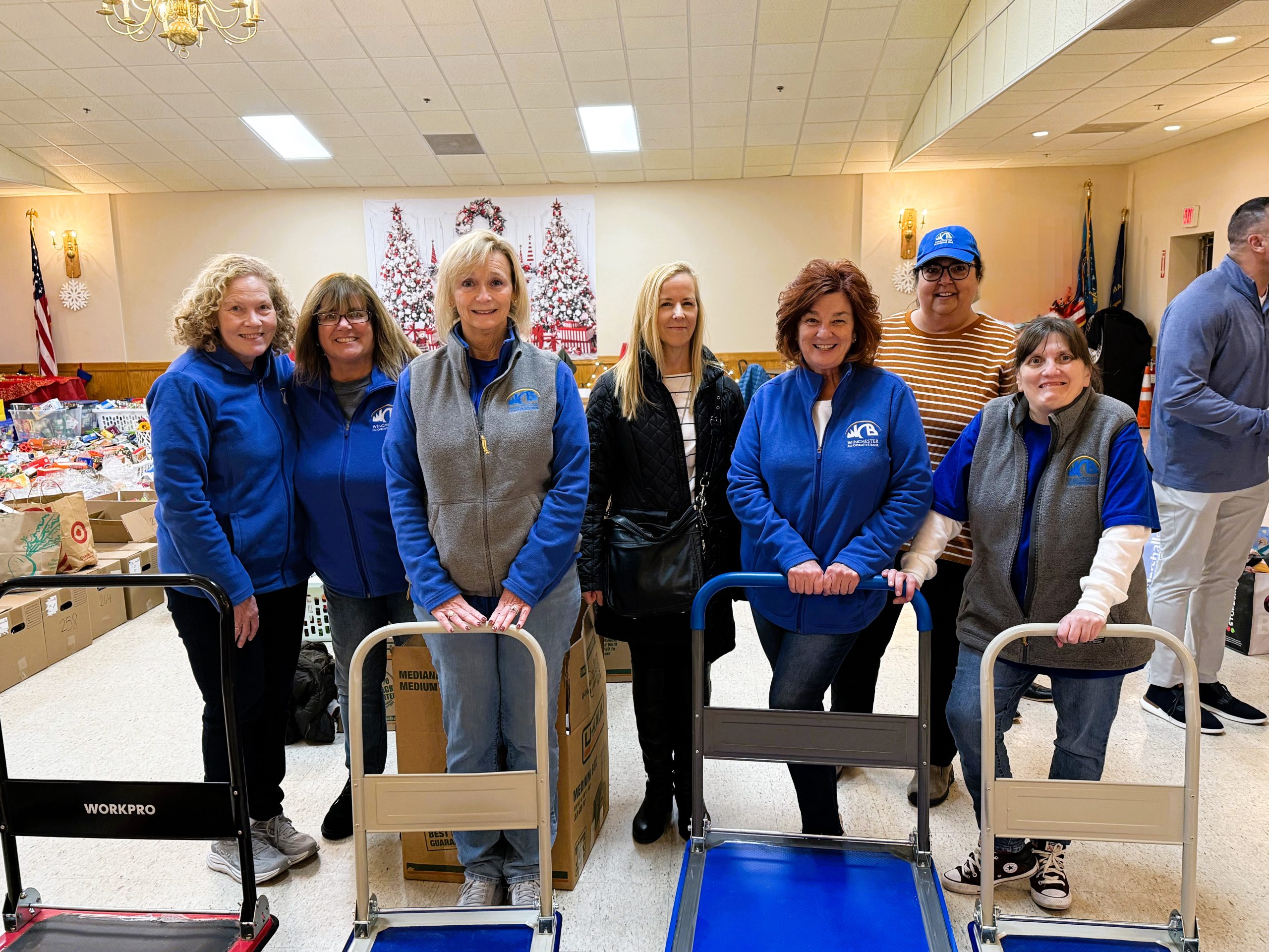 Group of employees in front of cart and food baskets