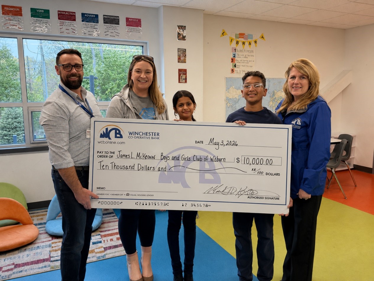 5 people standing in front of a check with colored floor underneath