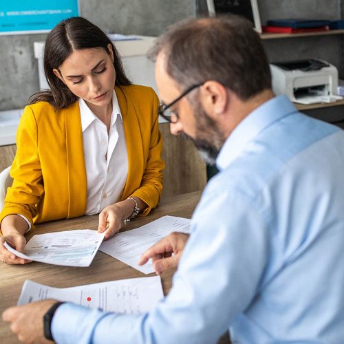 Business Advice Two business people reviewing paperwork